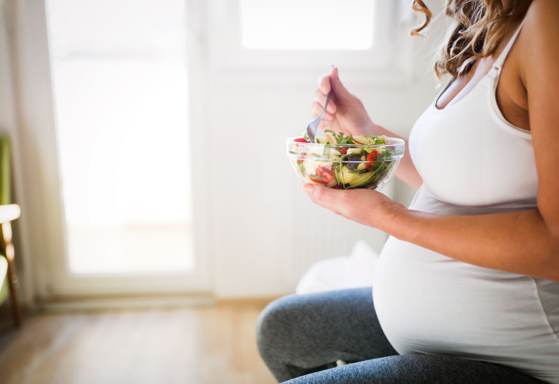 Schöne schwangere Frau, die sich gesund ernährt